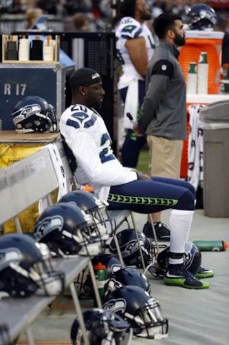 Jeremy Lane sitting during the national anthem in Oakland. Source: Seattle Times